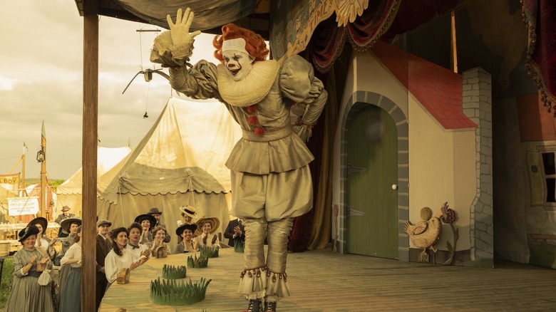 பில் ஸ்கார்ஸ்கார்டின் பாப் கிரே மேடையில் இருந்து பென்னிவைஸ் தி டான்சிங் கோமாளியாக அலைகிறார், அதில் வெல்கம் டு டெர்ரி