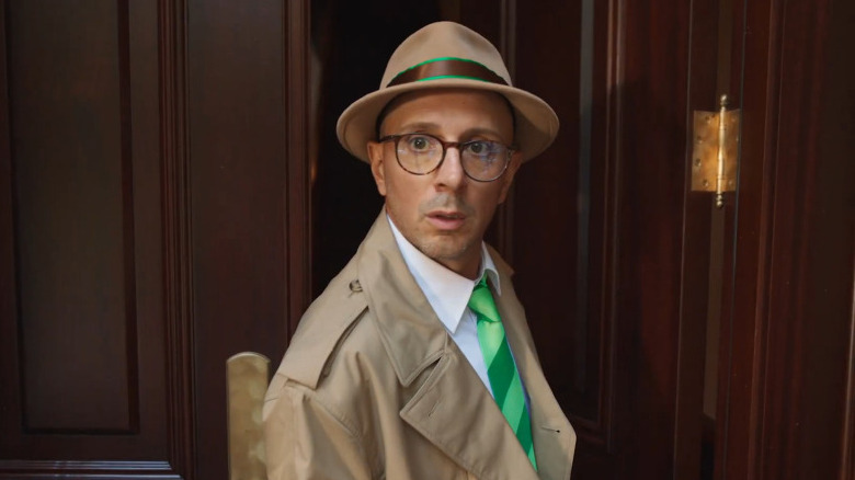 Steve looking shocked in a detective's coat and hat while stepping out of his front door in Blue's Big City Adventure