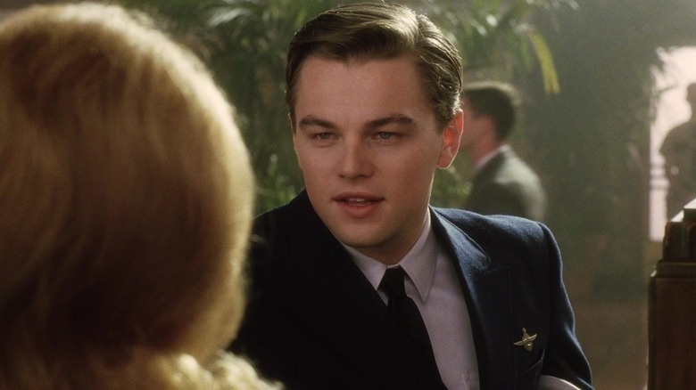 Leonard DiCaprio as Frank Abagnale Jr. talks to a bank teller in 