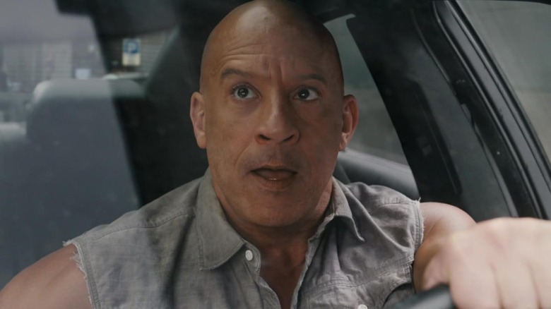 Vin Diesel as Dominic Toretto driving a car in Fast X