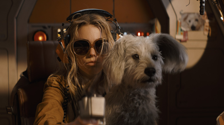 Kara (Milly Alcock) sitting with Krypto in "Supergirl."