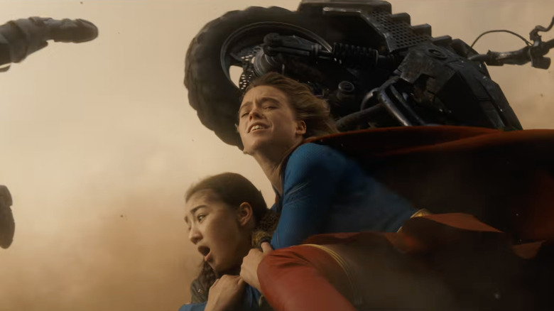 Milly Alcock as Kara Zor-El protects Eve Ridley as Ruthye Marye Knoll in Supergirl (2026)