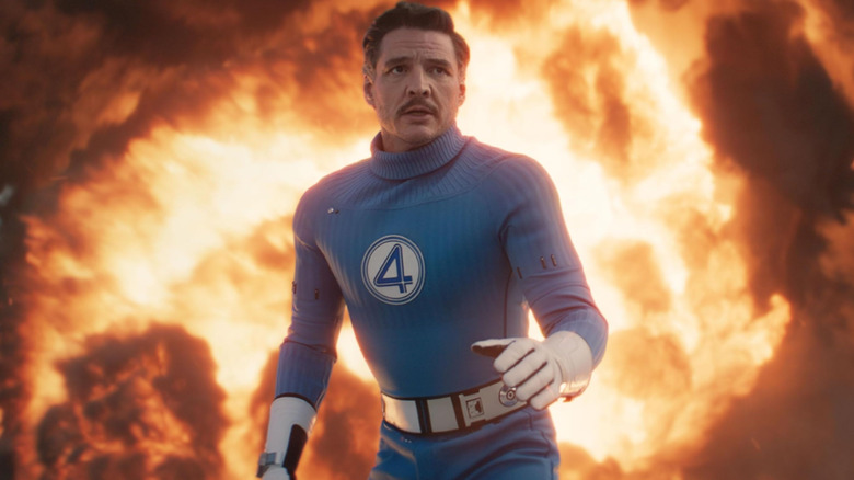 Pedro Pascal as Reed Richards standing in front of flames in The Fantastic Four: First Steps