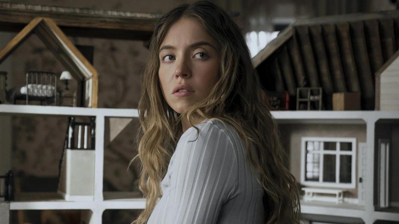 Sydney Sweeney as Millie by the dollhouse in The Housemaid