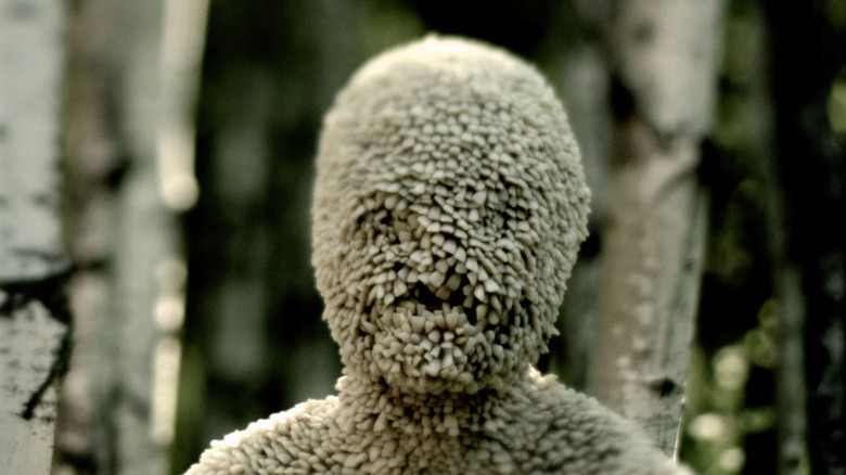 The tooth monster standing in the trees in Channel Zero season 1