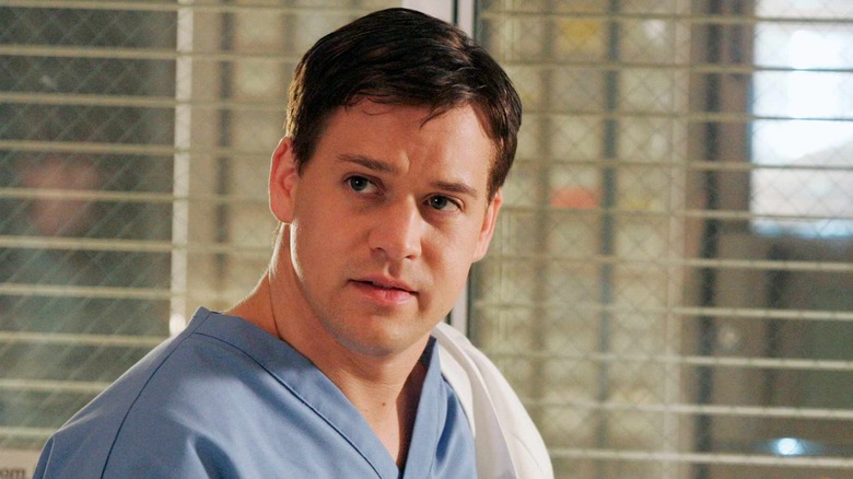 George in scrubs in a patient room on Grey's Anatomy