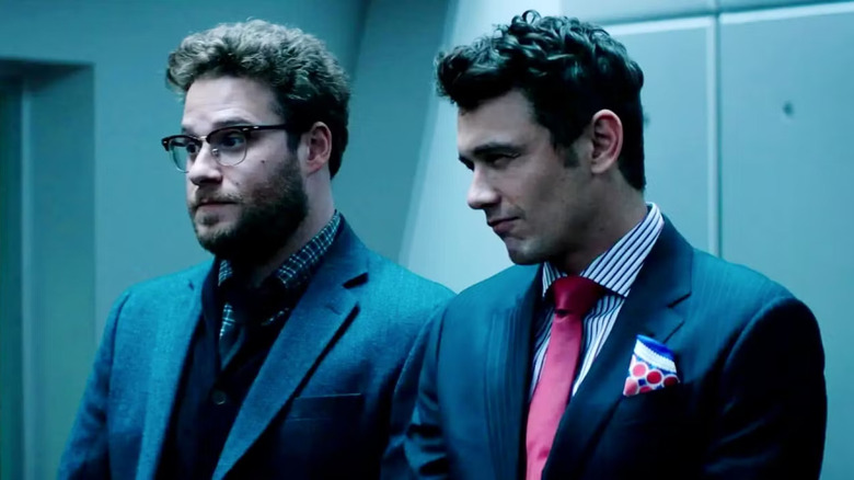 Seth Rogen and James Franco in The Interview, wearing suits and looking suspicious