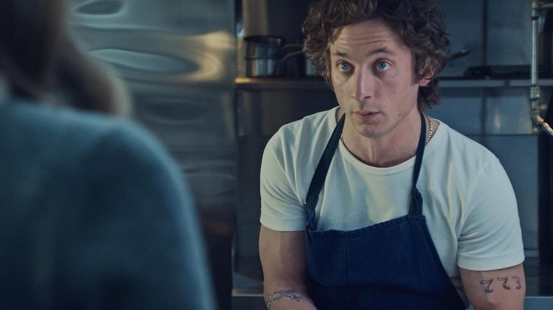 Jeremy Allen White as Carmy wearing an apron in The Bear