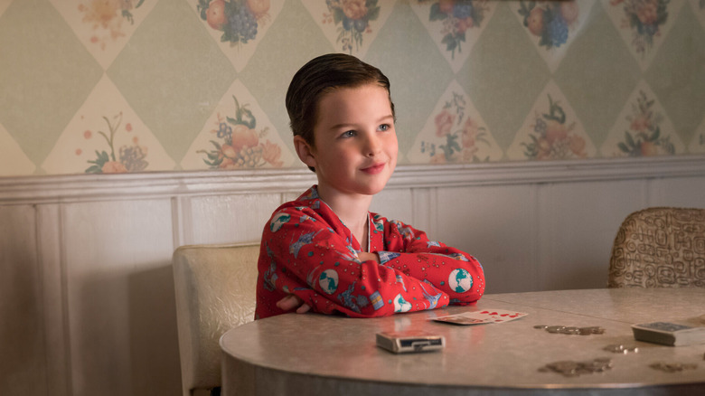 Young Sheldon sitting at a table in his pajamas on Young Sheldon