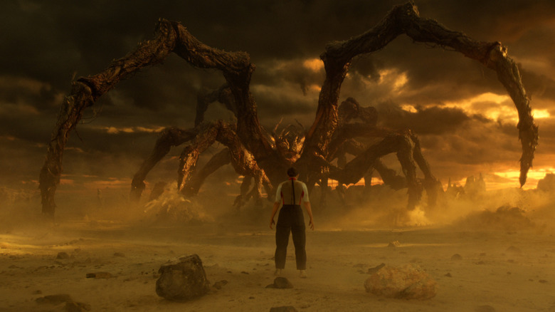 Eleven facing off against a giant Mind Flayer spider monster in Stranger Things