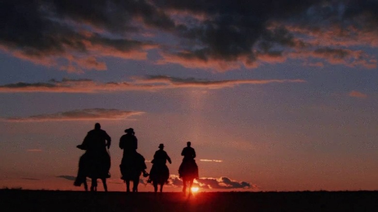 The cast of Indiana Jones and the Last Crusade riding off into the sunset on horseback.