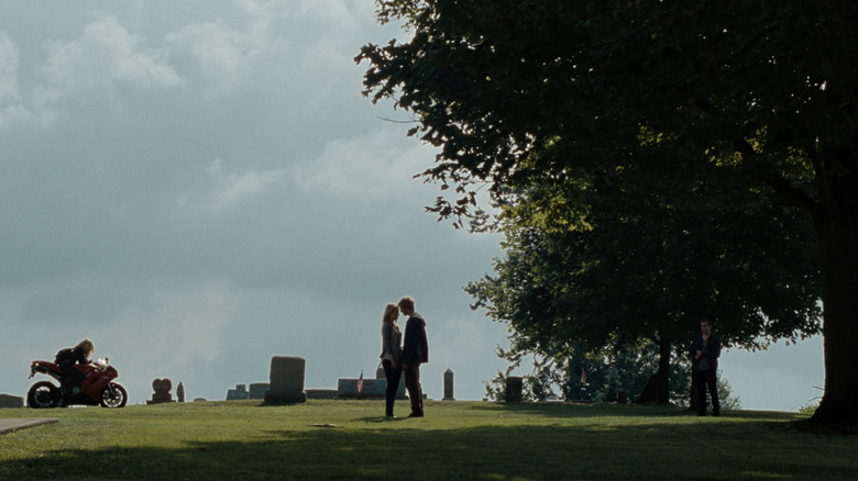 Alex Pettyfer as John Smith standing with Dianna Agron as Sarah Hart in a cemetery in I Am Number Four