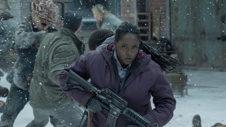Maria holding a gun fighting in The Last of Us