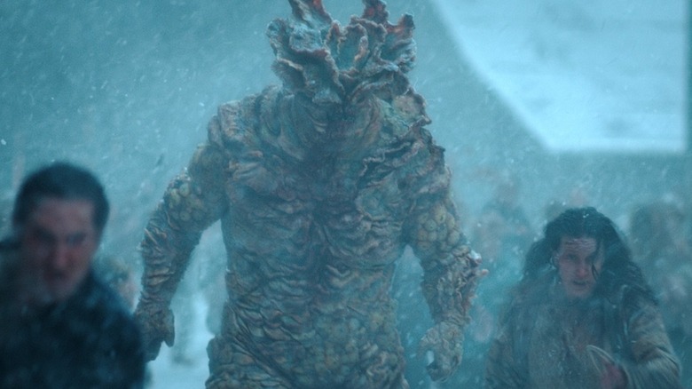 A Bloater walking alongside infected in The Last of Us