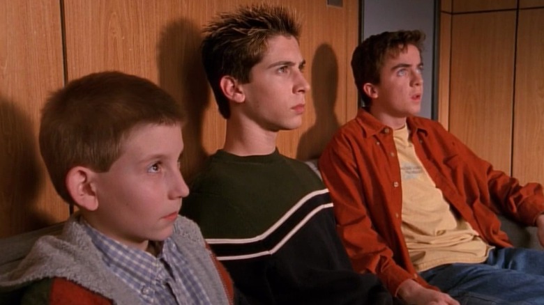 Dewey, Reese, and Malcolm sitting in an office looking worried in Malcolm in the Middle
