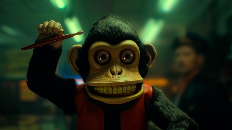 Adam Scott as Petey Shelburn Sr featured out of focus to the right of the titular toy in 