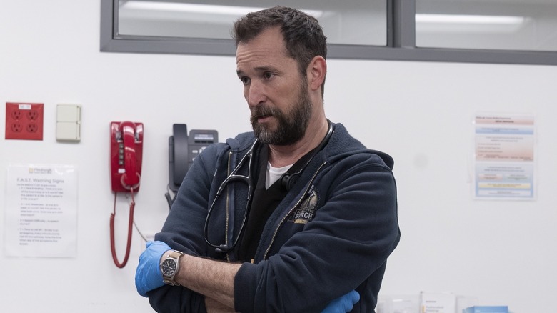 Dr. Robbie standing with a weapon crossed on Pete