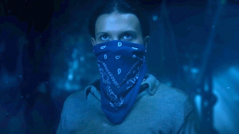 Eleven wearing a bandana on her face in Stranger Things