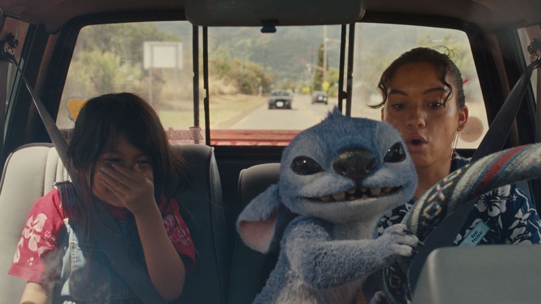Maia Kealoha as Lilo, Stitch, and Sydney Agudong as Nani driving a truck in Lilo & Stitch (2025)