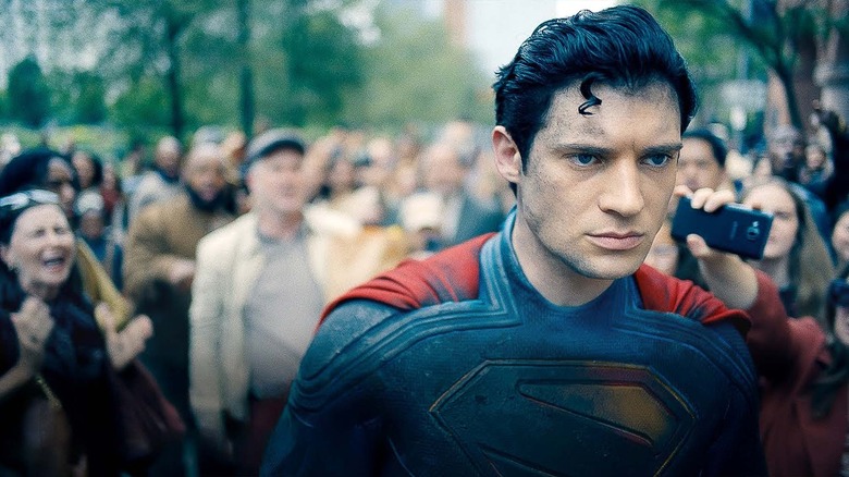 Superman, unhappy, walking through a crowd in Superman