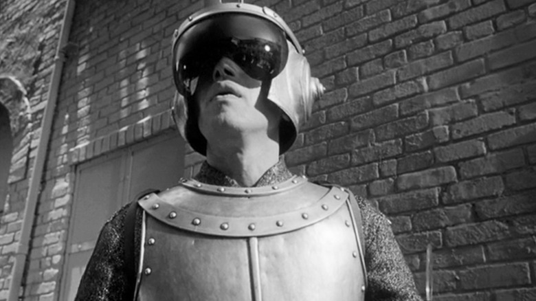 Michael Ansara's Qarlo Clobregnny is seen from a low angle as he stands in an alley in The Outer Limits
