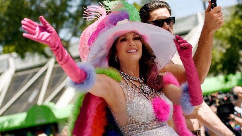Lisa Vanderpump waving from a pride parade float on Vanderpump Rules