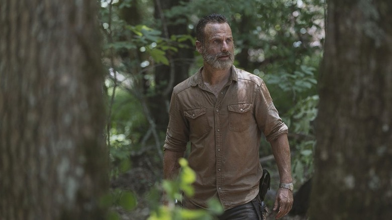 Andrew Lincoln's Rick Grimes walking through the woods in The Walking Dead season 9