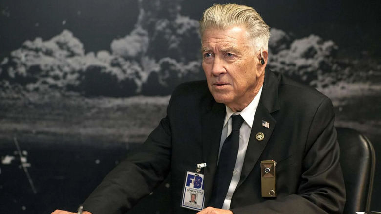 Gordon Cole sitting in front of a photo of an atomic explosion in Twin Peaks: The Return