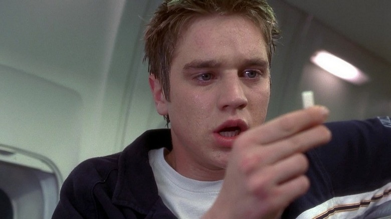 Alex Browning (Devon Sawa) has a sudden realization on an airplane in Final Destination (2000)