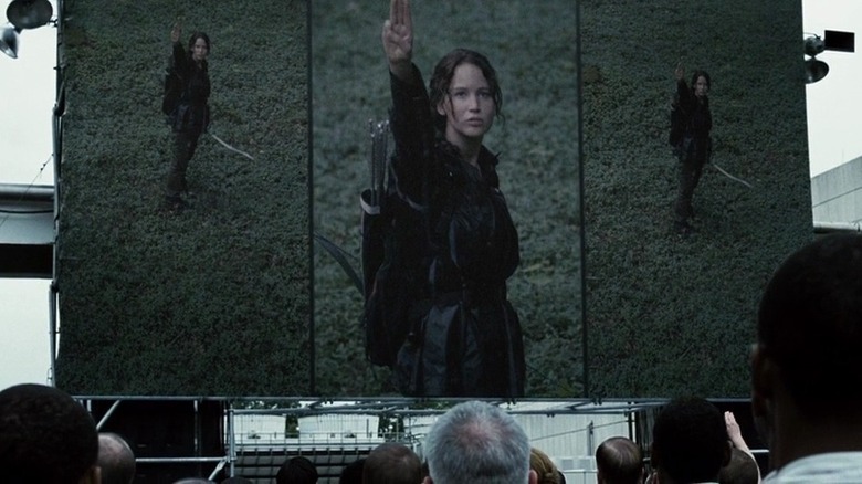 Katniss raising three finger symbol