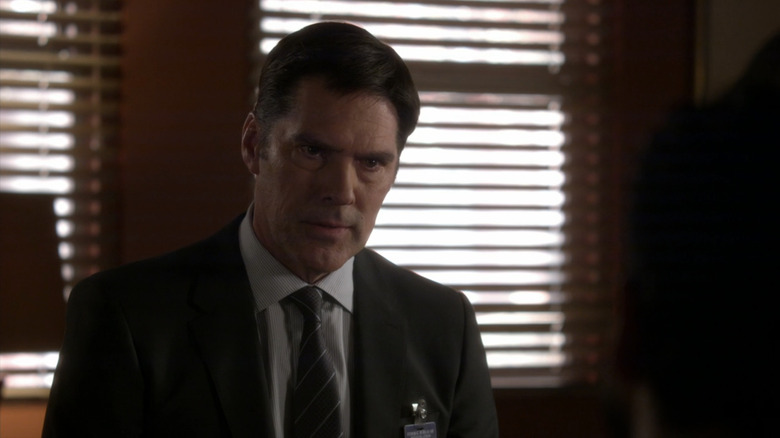 Thomas Gibson's Aaron Hotchner sits in an office in Criminal Minds