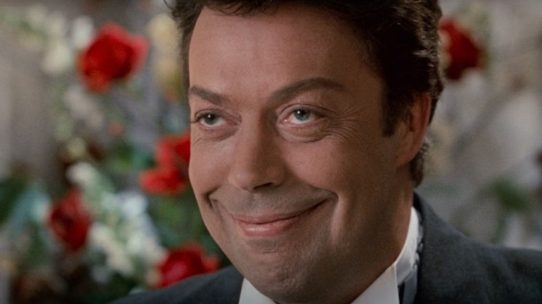 Tim Curry smiling as Mr. Hector in Home Alone 2: Lost in New York