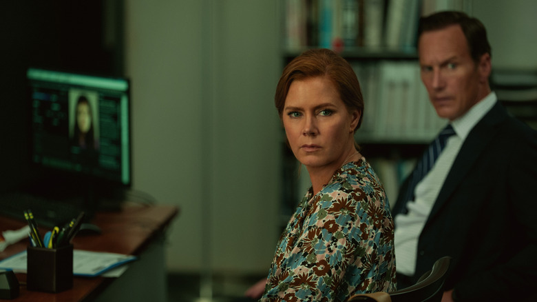 Amy Adams as Anna Bowden and Patrick Wilson as Tom Bowden sitting at a desk in Cape Fear (2026)
