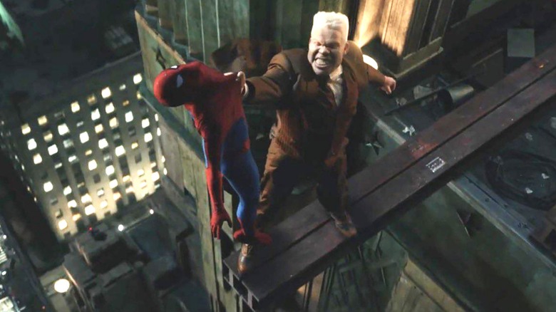 Krondon as Tombstone dangles Tom Holland as Spider-Man off the ledge of a building in Spider-Man: Brand New Day