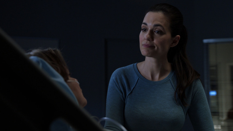 Torrey DeVitto's Dr. Natalie Manning stands in front of a hospital bed in Chicago Med