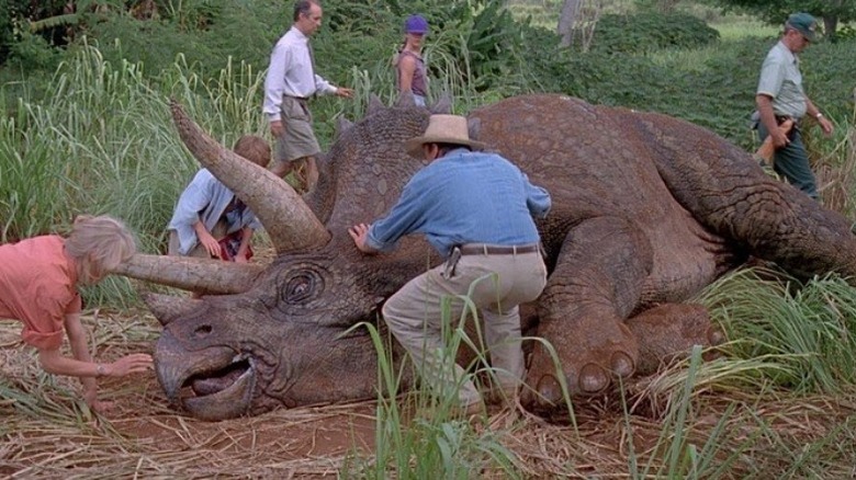 Grant and Sattler inspecting Triceratops