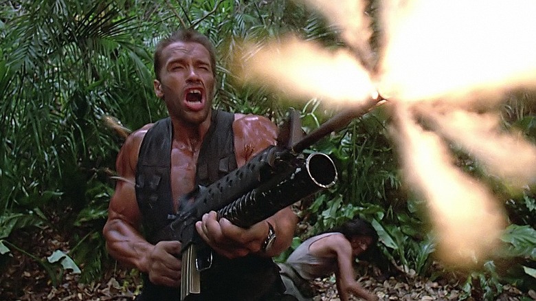 Predator Dutch fires an assault rifle