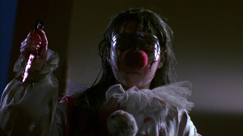Danielle Harris raising a knife in Halloween 4