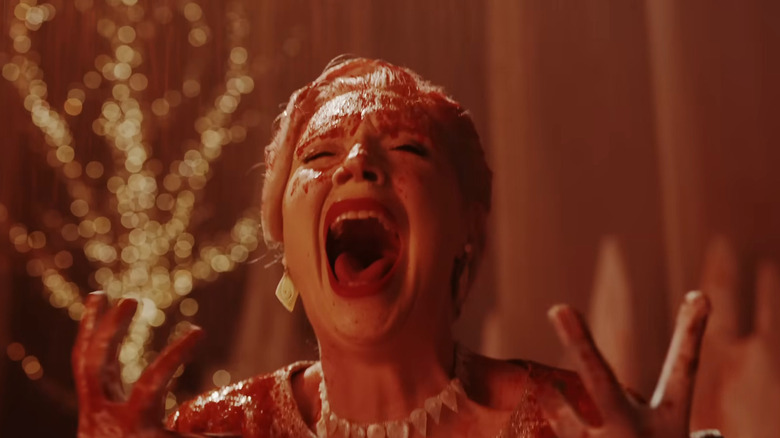 Someone being covered in blood in Wednesday