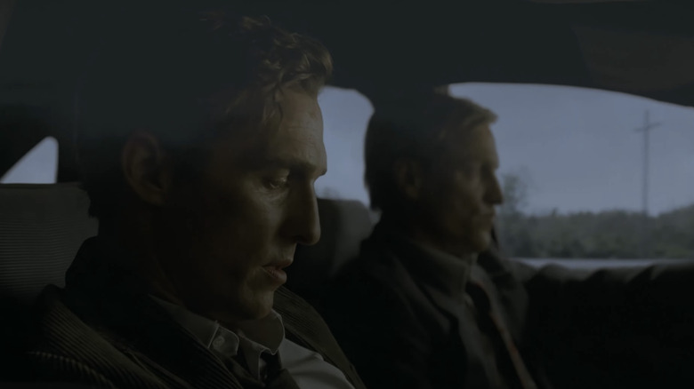 Matthew McConaughey as Rustin Cohle sits beside Woody Harrelson as Marty Hart in a car in True Detective