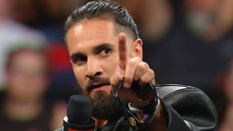 Seth Rollins holding a mic on WWE television