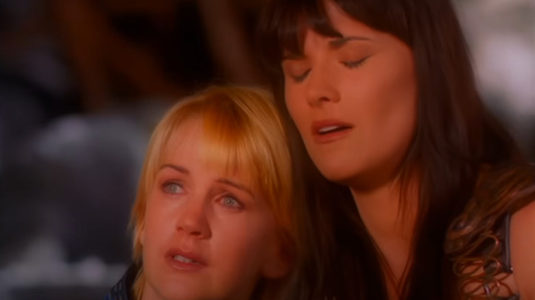 Gabrielle and Xena sitting together in Xena: Warrior Princess