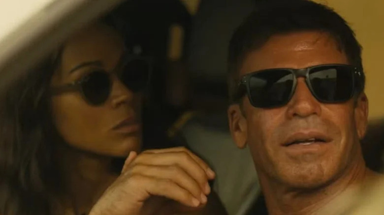 Taylor Sheridan as Cody Spears sits in a car alongside Zoe Saldaña as Joe McNamara in Lioness