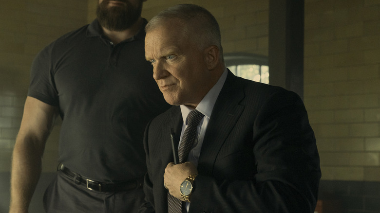 Zachary Beck standing in front of Paulie in Reacher