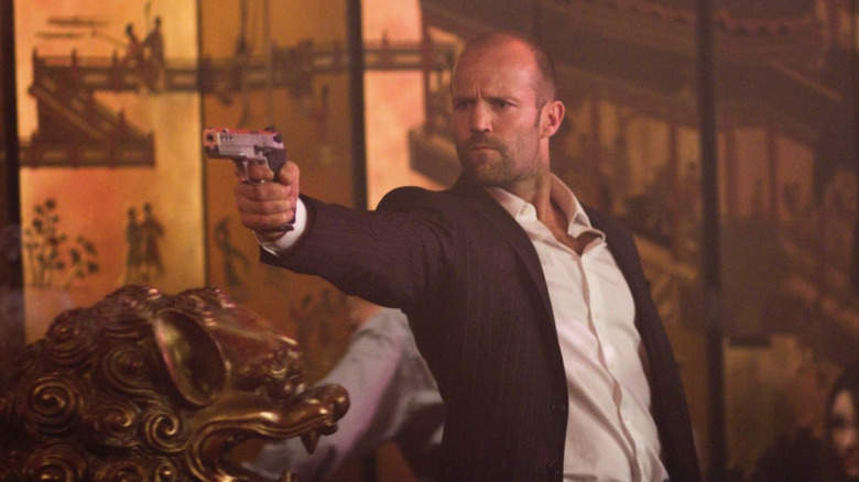 Jason Statham holds a gun in a restaurant Safe