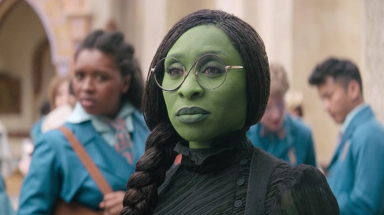 Cynthia Erivo as Elphaba Thropp smiling dryly in Wicked