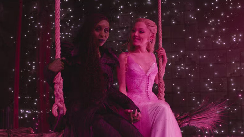 Elphaba and Glinda on a swing in front of stars in Wicked: For Good