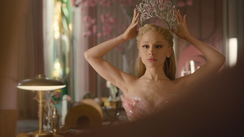 Glinda putting on her crown in a mirror in Wicked: For Good