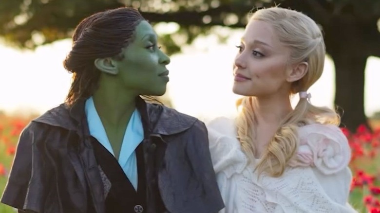 Elphaba and Glinda looking into each others' eyes in a meadow in Wicked: For Good