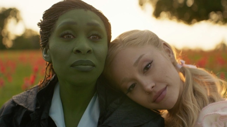Glinda resting her head on Elphaba's shoulder in Wicked: For Good